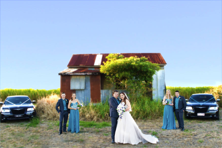 wedding party in front of rusty shed